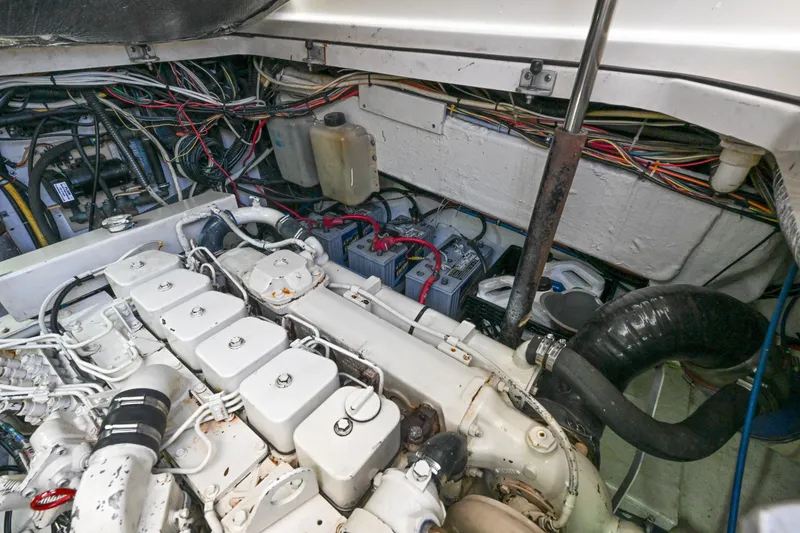 Slide: The Image of Engine room of a 2000 Pursuit 3400 Express boat, showcasing wiring and components. - 49