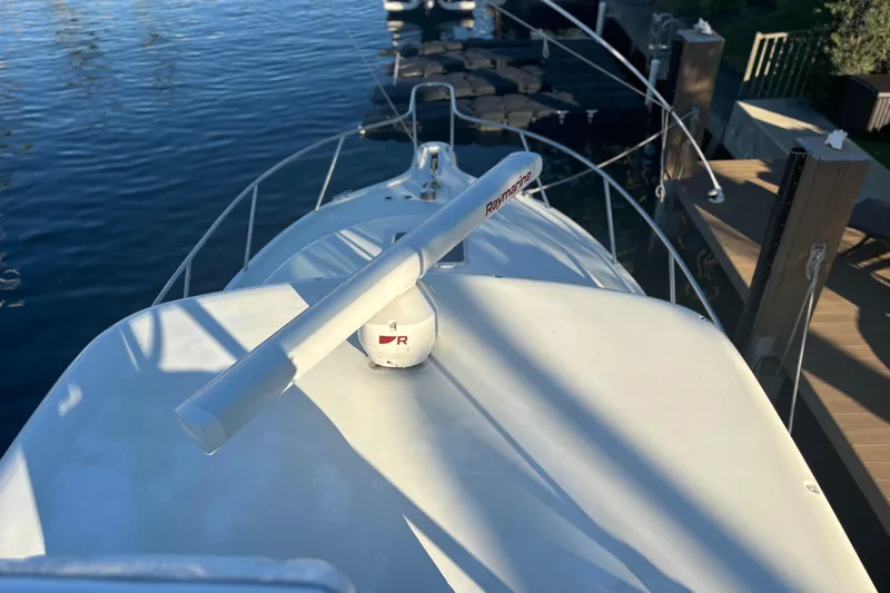 Slide: The Image of Aerial view of a 2000 Pursuit 3400 Express boat docked by a lush waterfront. - 5