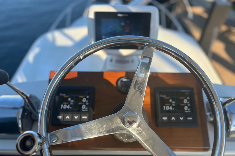 Slide: The Image of Aerial view of 2000 Pursuit 3400 Express boat docked by lush waterfront. - 6