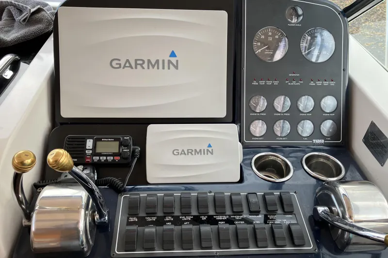 Slide: The Image of Tiara Yachts 1999 3500 Open dashboard with Garmin navigation and control panels. - 21