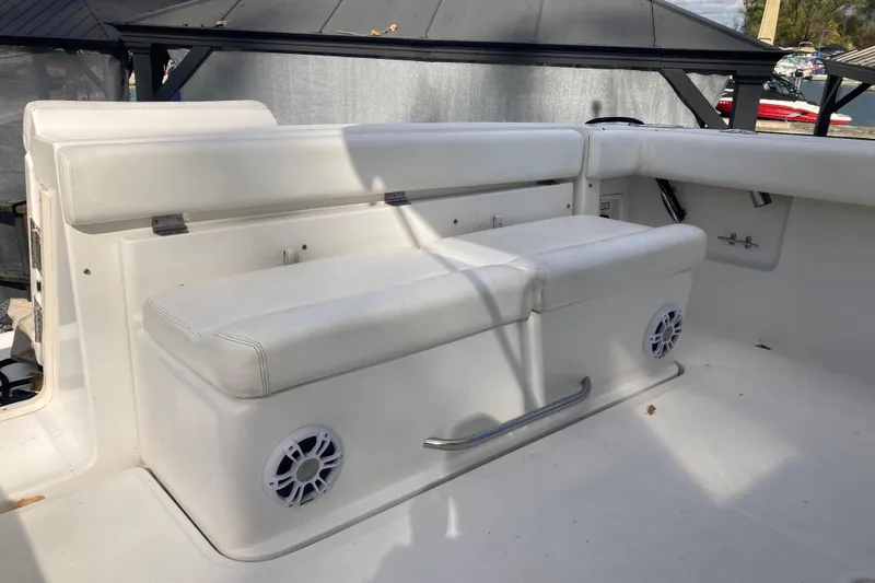 Slide: The Image of 1999 Tiara Yachts 3500 Open interior with white seating and built-in speakers. - 27