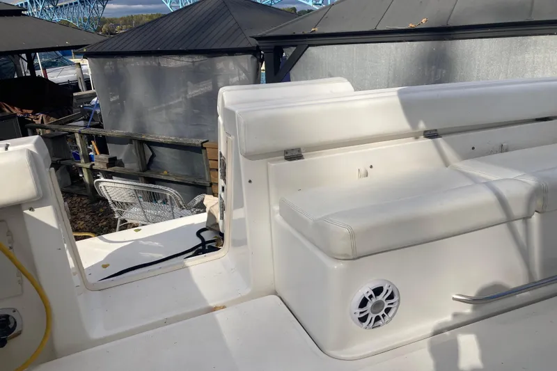 Slide: The Image of 1999 Tiara Yachts 3500 Open boat interior with white seating and speaker. - 28