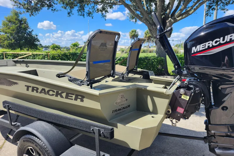 The Image of 2025 Tracker Grizzly 1650 T Prairie Wings Edition boat with Mercury engine on trailer. - 1