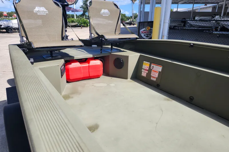 Slide: The Image of 2025 Tracker Grizzly 1650 T Prairie Wings Edition boat interior with seating and storage. - 7