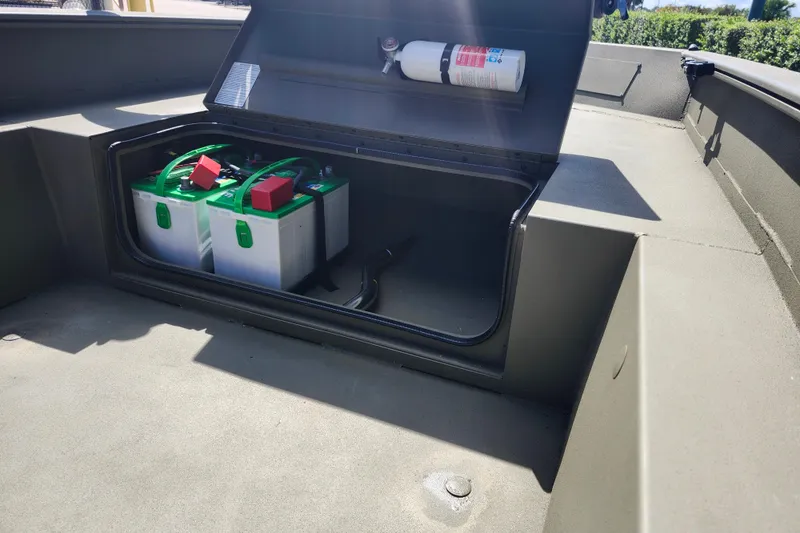 Slide: The Image of 2025 Tracker Grizzly 1650 T Prairie Wings Edition boat battery compartment with fire extinguisher. - 9