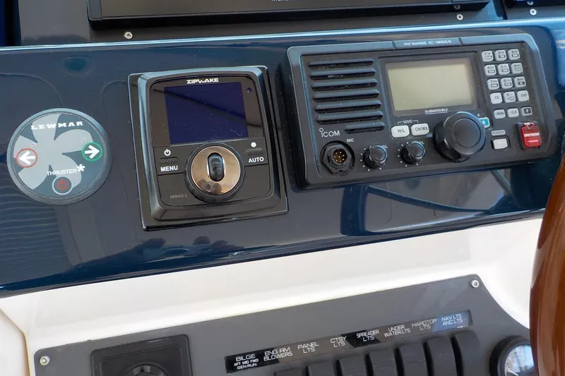 Slide: The Image of Control panel of a 2009 Tiara Yachts 3900 Open, featuring navigation and communication equipment. - 12