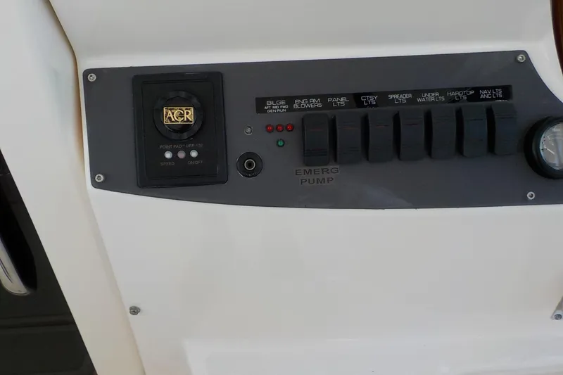 Slide: The Image of Control panel of a 2009 Tiara Yachts 3900 Open, featuring switches and an ACR device. - 13