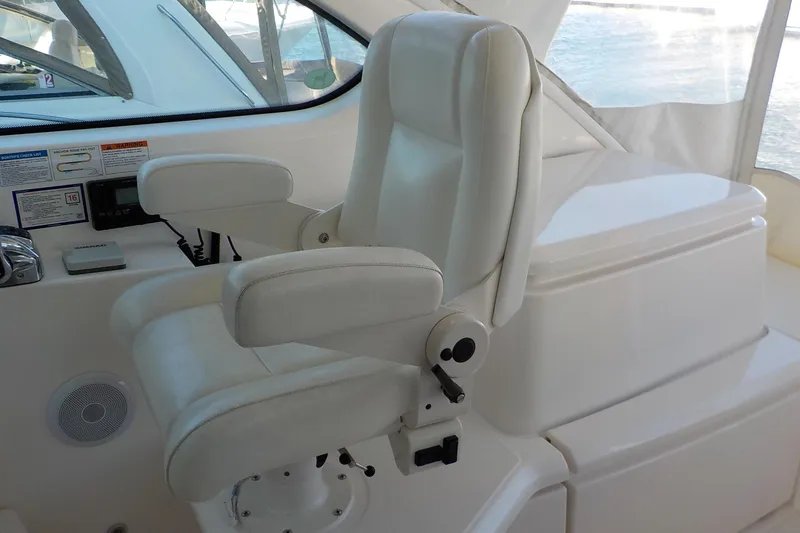 Slide: The Image of Captain's chair on 2009 Tiara Yachts 3900 Open, featuring white upholstery and control panel. - 14