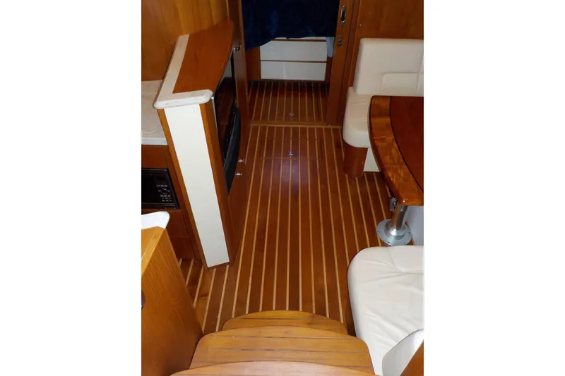 Slide: The Image of Interior of 2009 Tiara Yachts 3900 Open with wood flooring and seating area. - 28