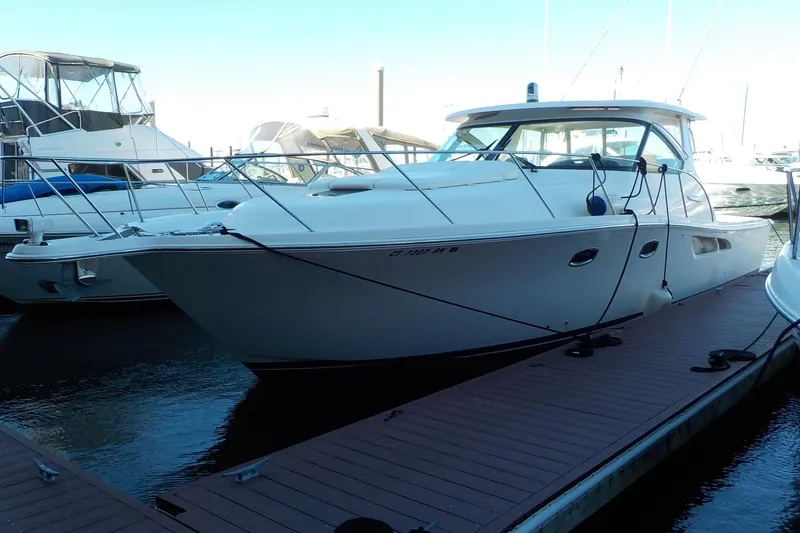 Slide: The Image of 2009 Tiara Yachts 3900 Open docked at marina, side view. - 3