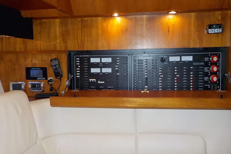 Slide: The Image of Control panel of a 2009 Tiara Yachts 3900 Open, featuring AC and DC systems. - 30