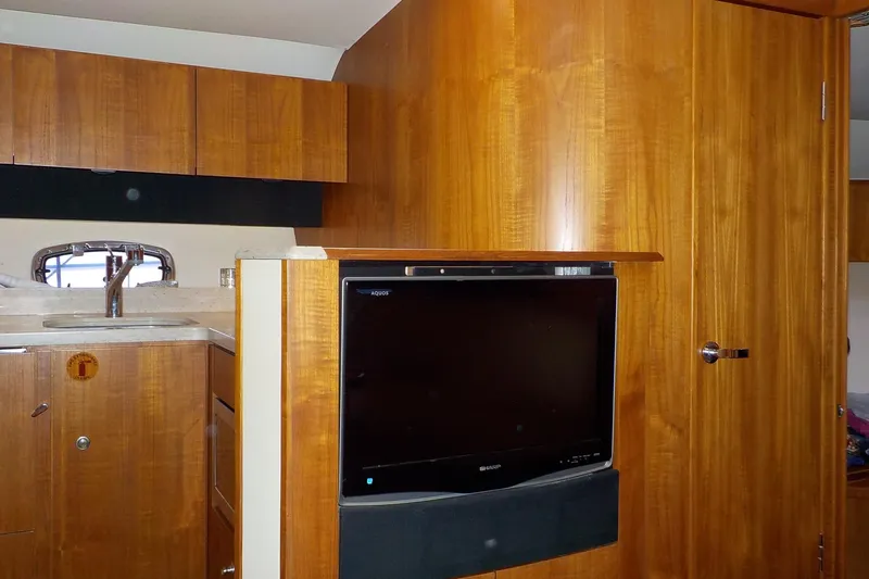 Slide: The Image of 2009 Tiara Yachts 3900 Open interior with wood cabinetry and built-in TV. - 31