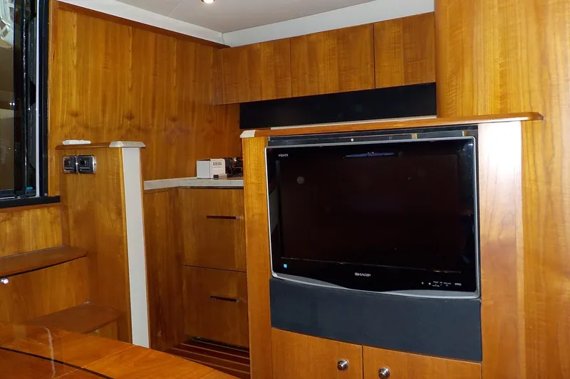 Slide: The Image of 2009 Tiara Yachts 3900 Open interior with wood paneling and built-in TV. - 32