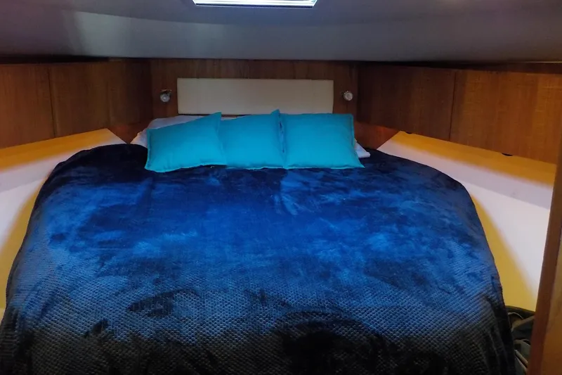 Slide: The Image of Luxurious cabin interior of 2009 Tiara Yachts 3900 Open with cozy bedding. - 34