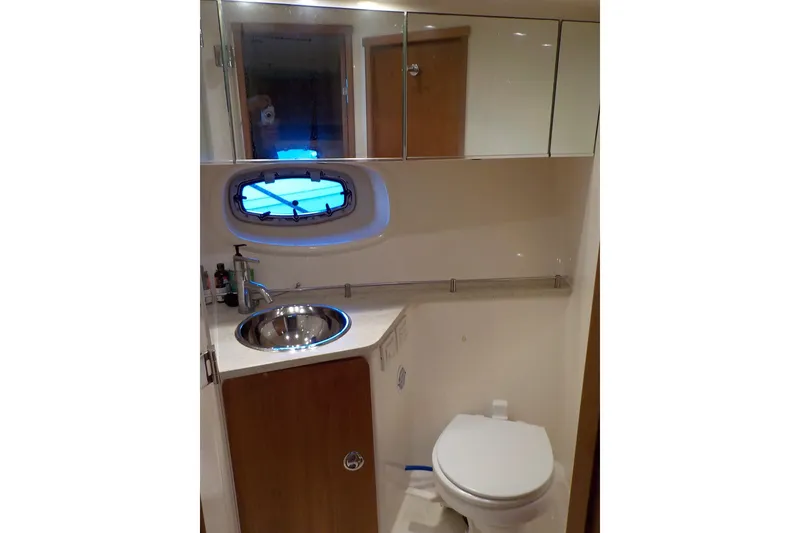 Slide: The Image of Luxurious bathroom in 2009 Tiara Yachts 3900 Open, featuring sink, toilet, and mirrored cabinets. - 36