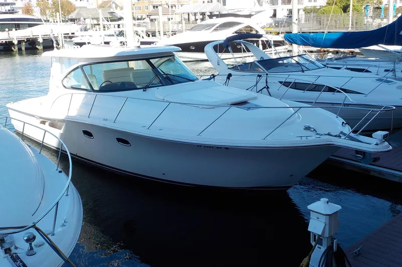 Slide: The Image of 2009 Tiara Yachts 3900 Open docked in a marina, surrounded by other boats. - 4