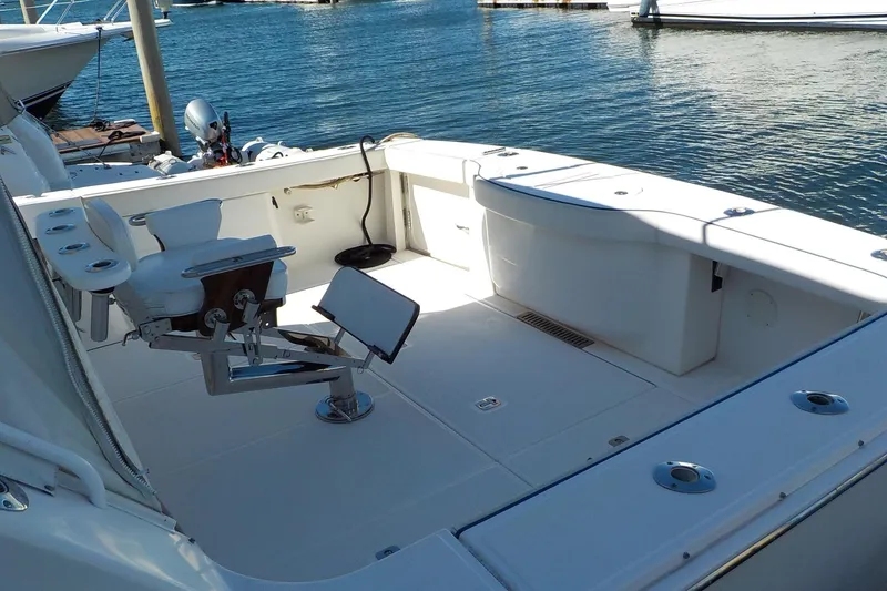 Slide: The Image of 2009 Tiara Yachts 3900 Open boat deck with fishing chair, docked by the water. - 45