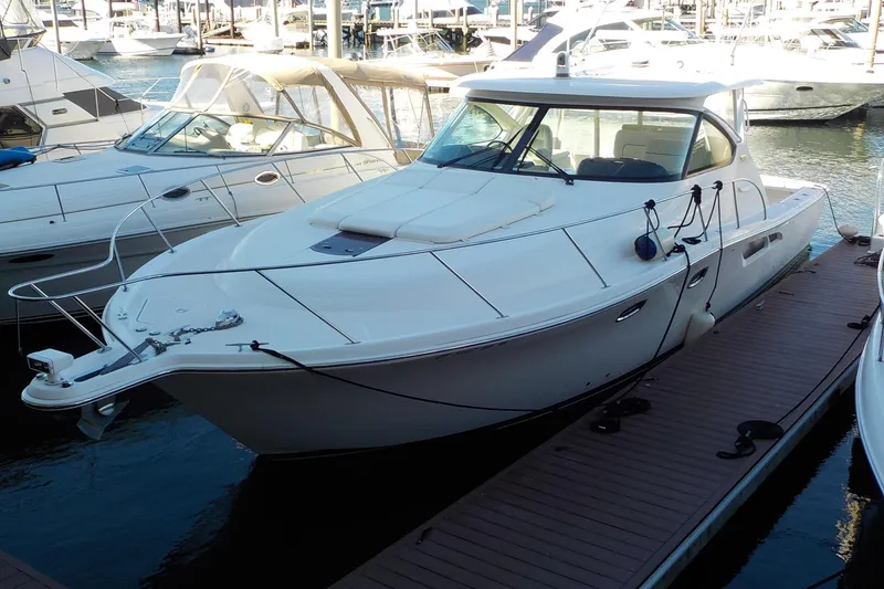 Slide: The Image of 2009 Tiara Yachts 3900 Open docked at marina, surrounded by other boats. - 5