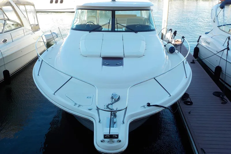 Slide: The Image of 2009 Tiara Yachts 3900 Open docked, showcasing sleek design and spacious deck. - 6