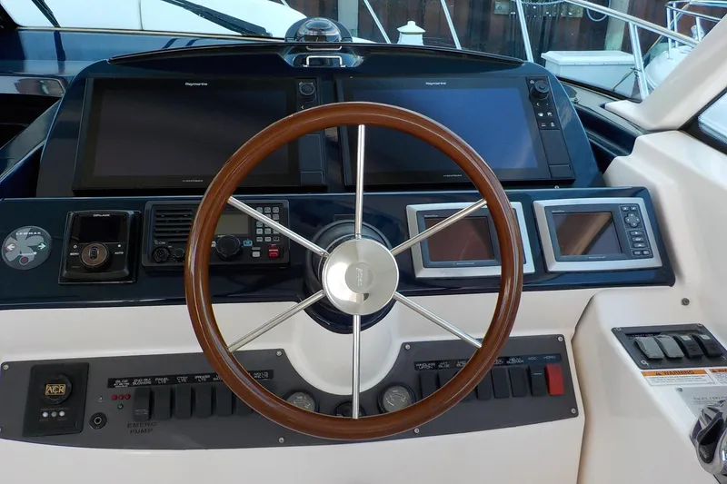 Slide: The Image of Helm of 2009 Tiara Yachts 3900 Open with navigation controls and wooden steering wheel. - 9