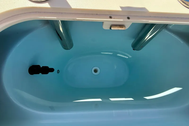 Slide: The Image of Livewell compartment in 2026 Scout 195 Sportfish boat, featuring a clean blue interior. - 15