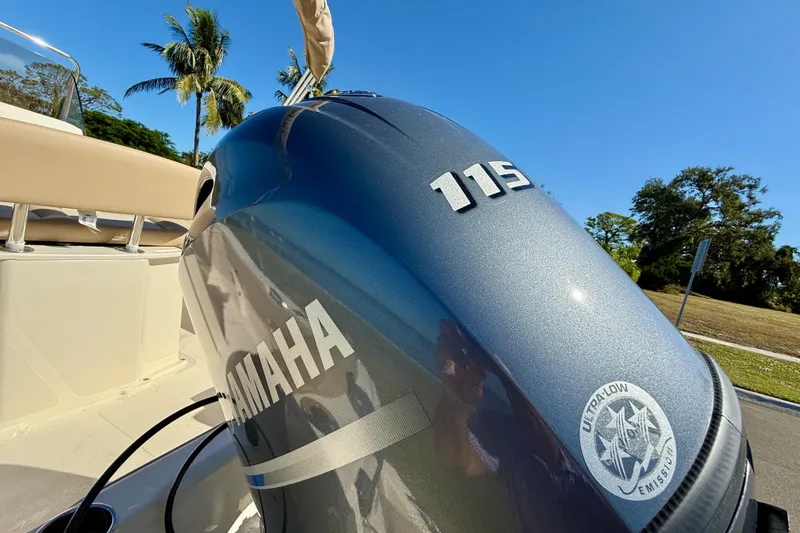 Slide: The Image of 2026 Scout 195 Sportfish with Yamaha 115 engine, sunny outdoor setting. - 28