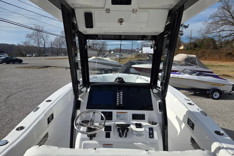 Slide: The Image of 2026 Sea Fox 268 Commander boat cockpit with steering wheel and control panel. - 10