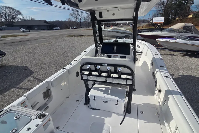 Slide: The Image of 2026 Sea Fox 268 Commander boat interior with console and seating, parked outdoors. - 11