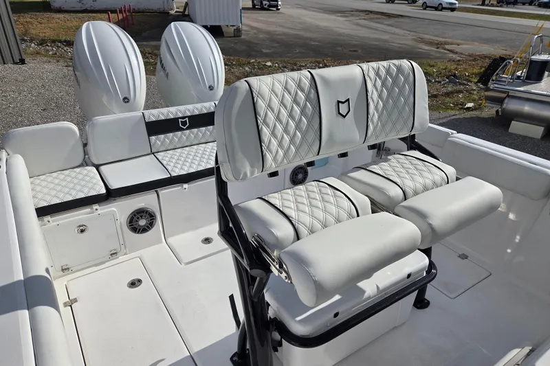 Slide: The Image of 2026 Sea Fox 268 Commander boat interior with white cushioned seating and dual engines. - 12