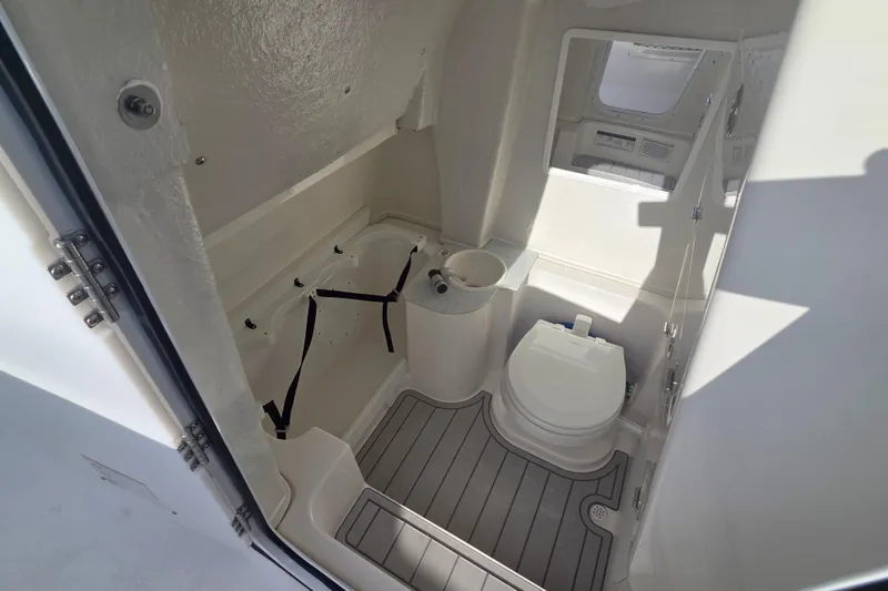 Slide: The Image of Interior of 2026 Sea Fox 268 Commander boat, featuring a compact marine toilet. - 16
