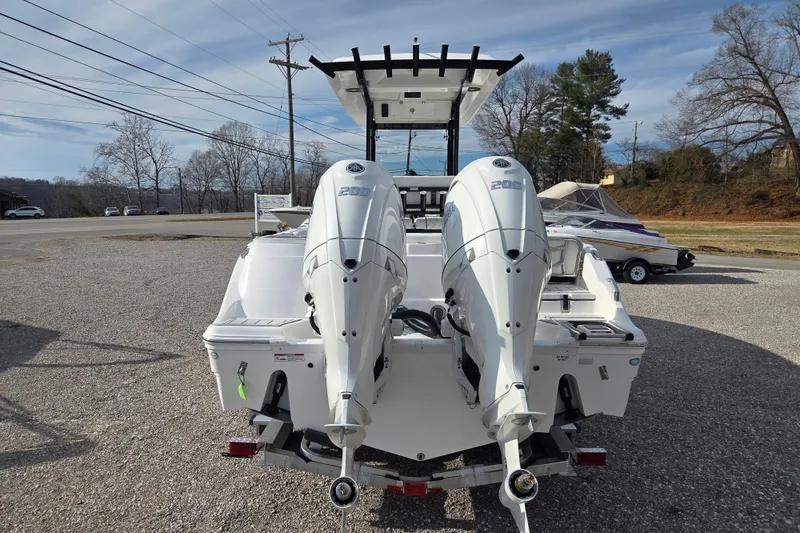Slide: The Image of 2026 Sea Fox 268 Commander boat with dual 200 horsepower engines, parked on gravel. - 4