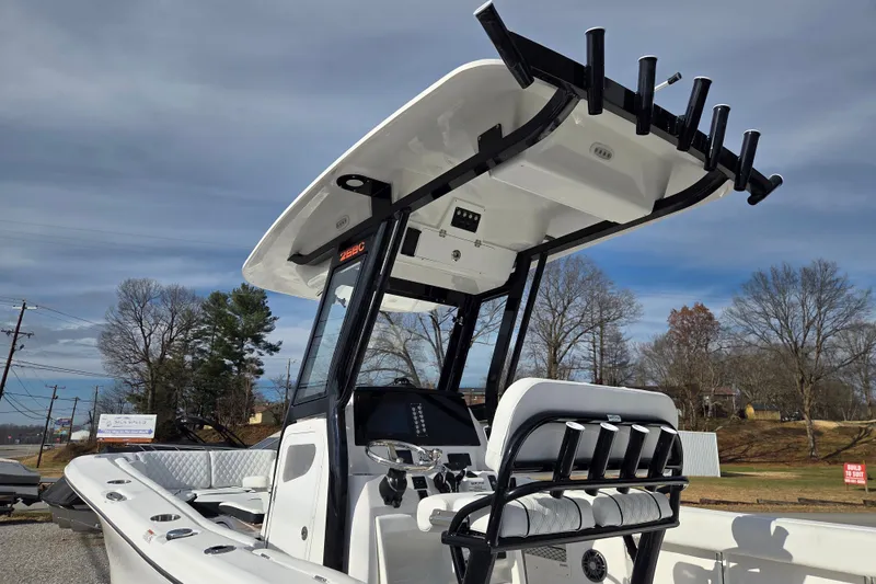 Slide: The Image of 2026 Sea Fox 268 Commander boat with T-top and rod holders, parked outdoors. - 8