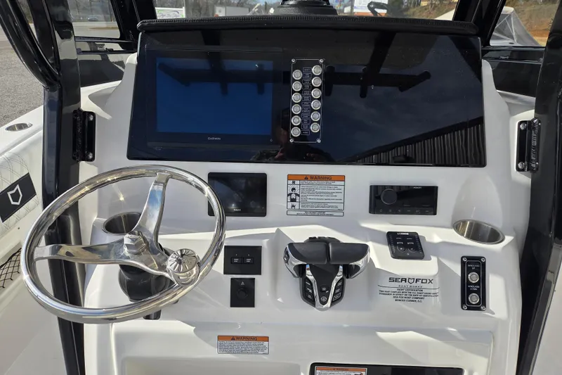 Slide: The Image of 2026 Sea Fox 268 Commander boat dashboard with steering wheel and control panel. - 9