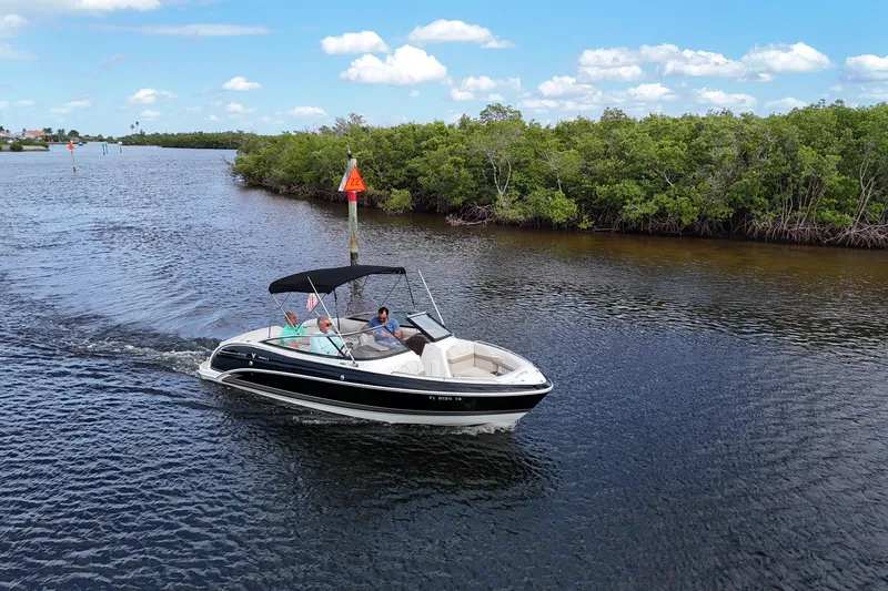 The Image of 2014 Formula 240 Bowrider cruising on a scenic river with lush greenery. - 0