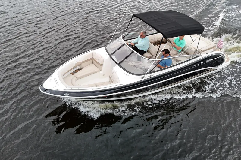 Slide: The Image of 2014 Formula 240 Bowrider cruising on water with passengers under a black canopy. - 1