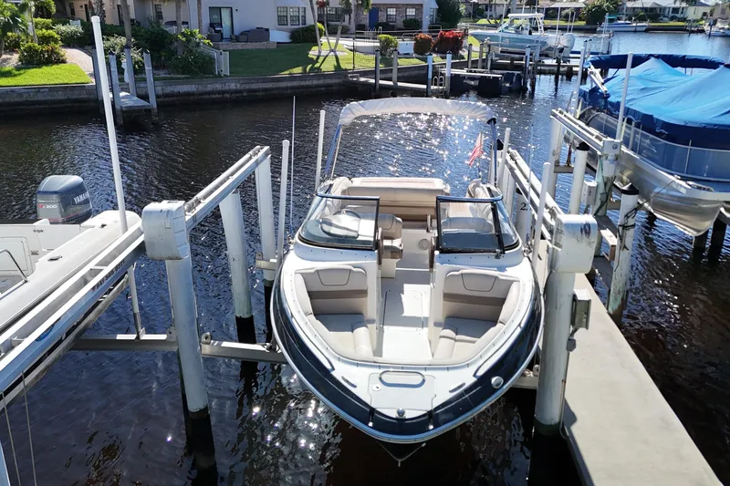 Slide: The Image of 2014 Formula 240 Bowrider boat docked at marina, sunny day, waterfront homes in background. - 12