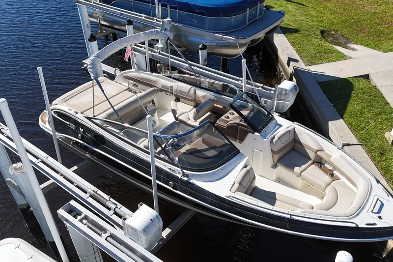 Slide: The Image of 2014 Formula 240 Bowrider boat docked, featuring spacious seating and sleek design. - 15