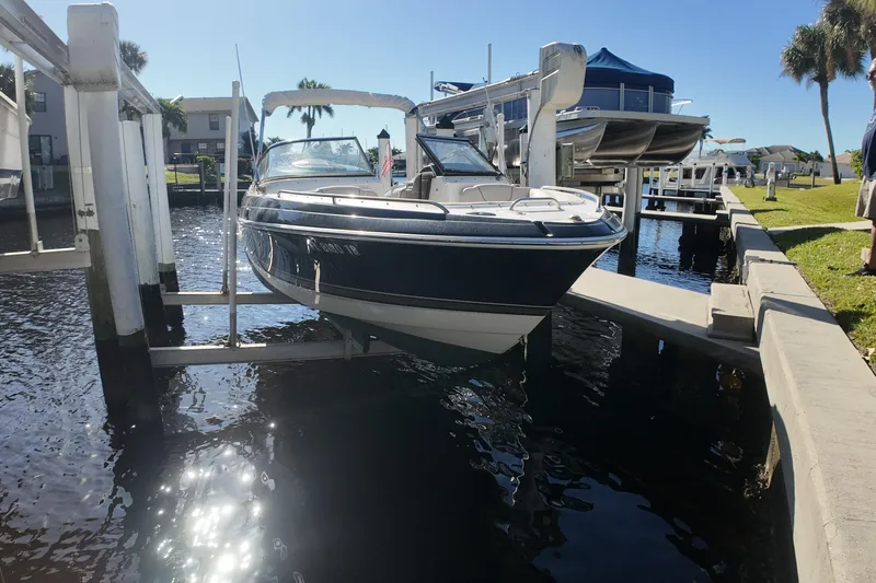 Slide: The Image of 2014 Formula 240 Bowrider boat docked on a sunny day. - 17