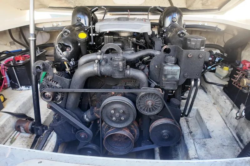 Slide: The Image of Engine compartment of a 2014 Formula 240 Bowrider boat, showcasing mechanical components. - 25