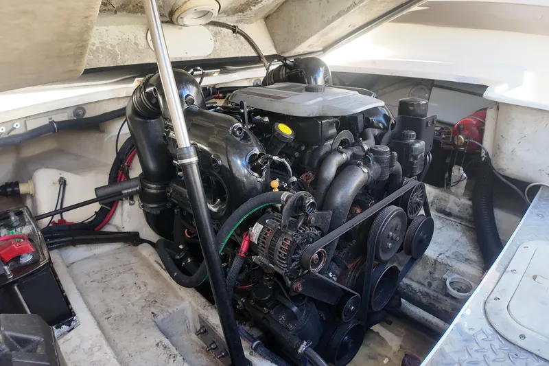 Slide: The Image of Engine compartment of a 2014 Formula 240 Bowrider boat, showcasing detailed mechanics. - 27