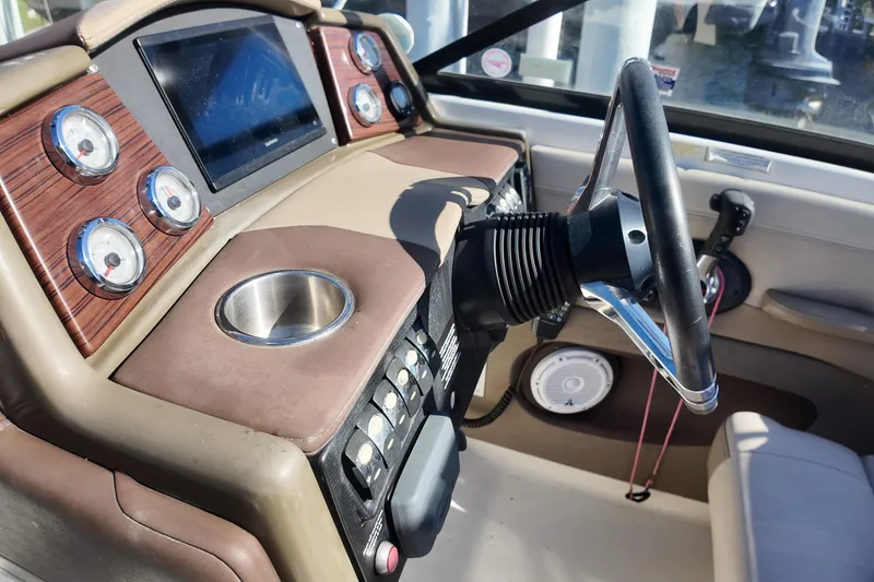 Slide: The Image of 2014 Formula 240 Bowrider dashboard with gauges, steering wheel, and cup holder. - 35