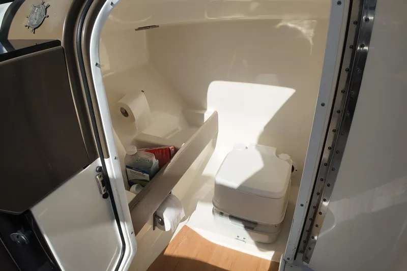 Slide: The Image of 2014 Formula 240 Bowrider boat interior with compact toilet and storage area. - 40