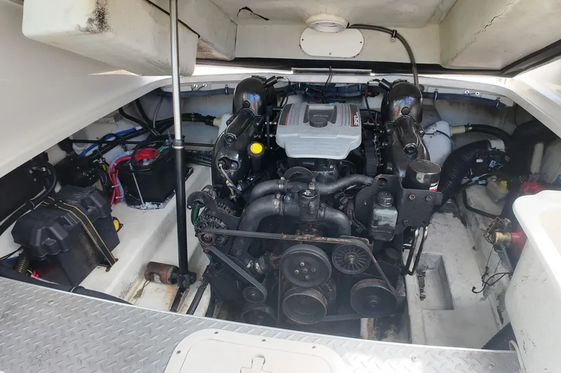 Slide: The Image of Engine compartment of a 2014 Formula 240 Bowrider boat, showcasing mechanical components. - 43