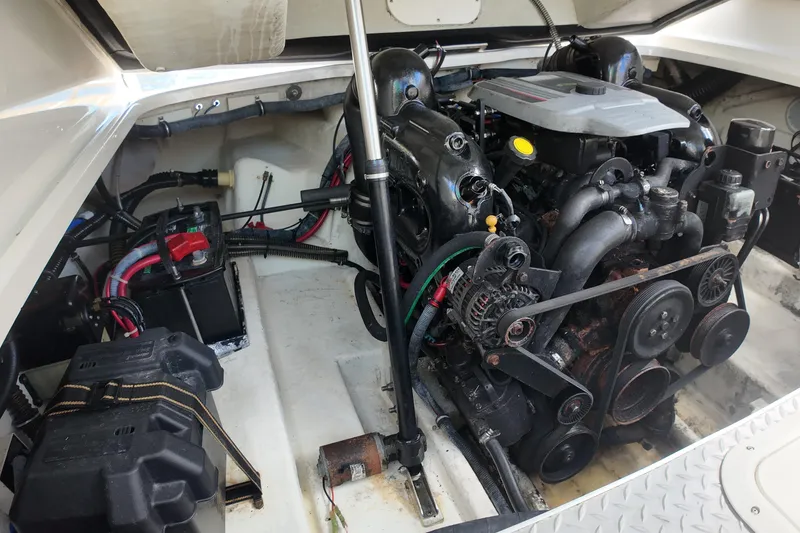 Slide: The Image of Engine compartment of a 2014 Formula 240 Bowrider boat, showcasing mechanical components. - 44
