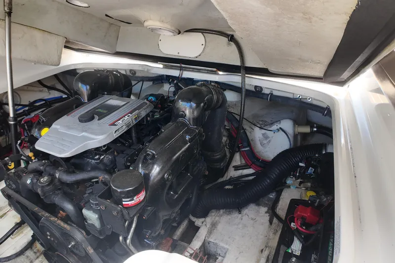 Slide: The Image of Engine compartment of a 2014 Formula 240 Bowrider boat, showcasing the engine and components. - 45