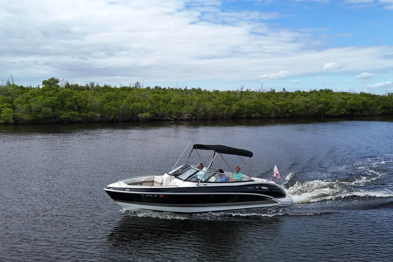 Slide: The Image of 2014 Formula 240 Bowrider cruising on a scenic river under a partly cloudy sky. - 50