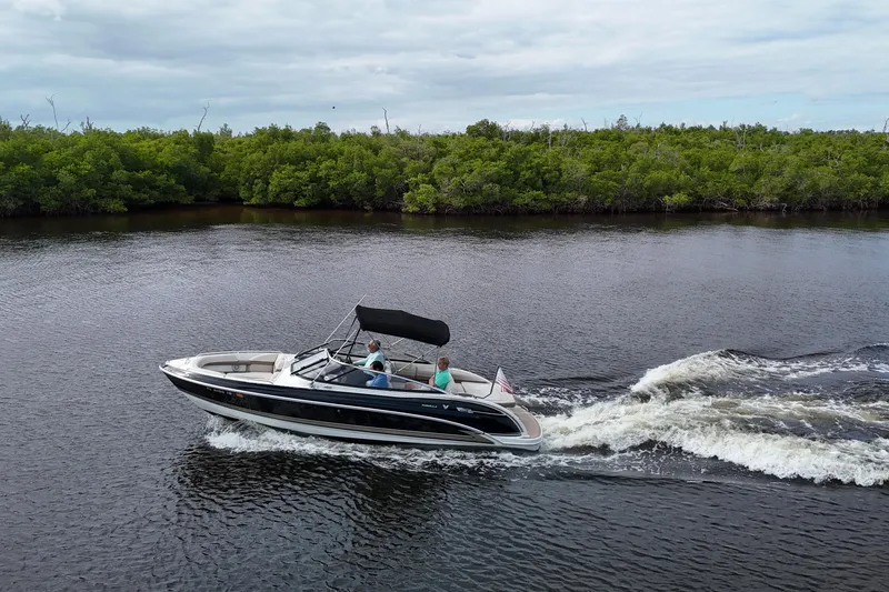Slide: The Image of 2014 Formula 240 Bowrider cruising on a river with lush green shoreline. - 51