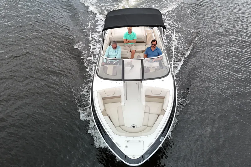 Slide: The Image of 2014 Formula 240 Bowrider cruising on water with three passengers onboard. - 55