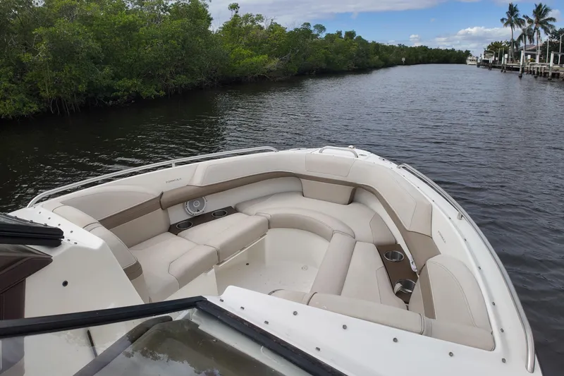 Slide: The Image of 2014 Formula 240 Bowrider boat with spacious seating on a calm river. - 59