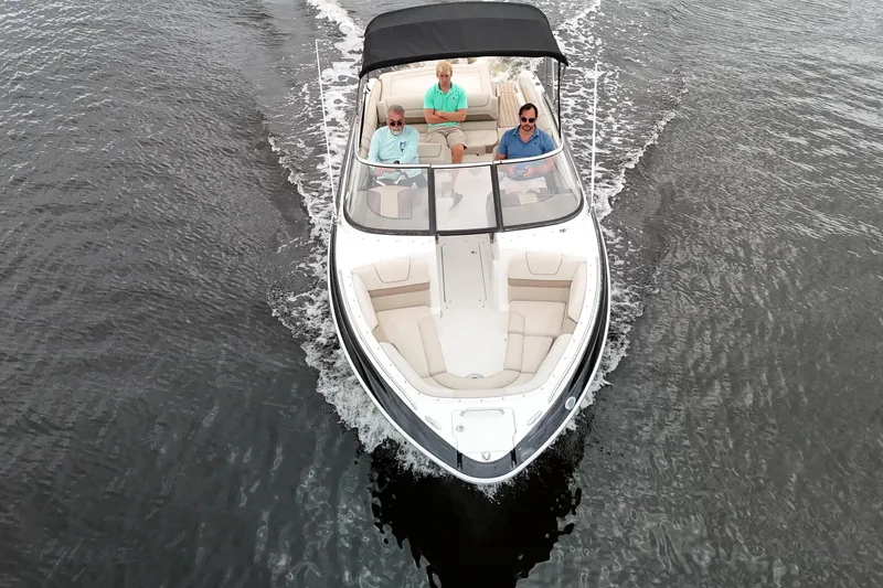 Slide: The Image of 2014 Formula 240 Bowrider cruising on water with three passengers onboard. - 6